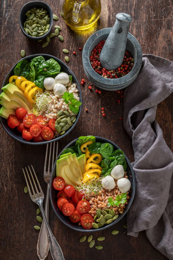 Diet salad with avocado, tomatoes, cheese and groats.